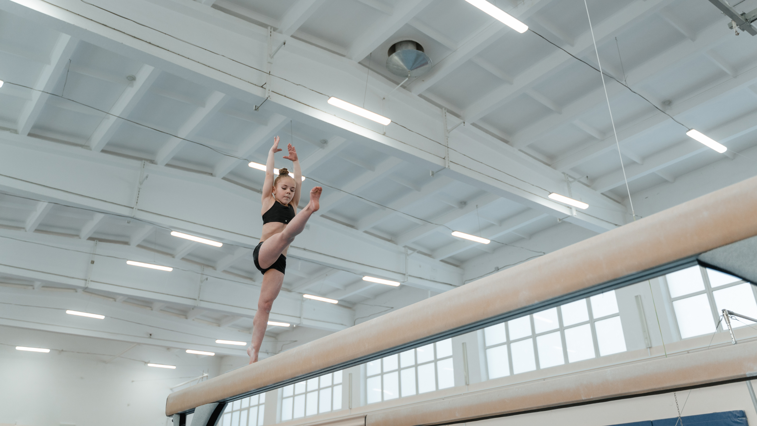 Young gymnast on the balance beam
